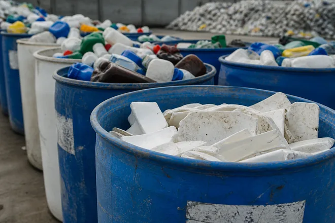 Used HDPE drums and rigid plastic waiting to be recycled