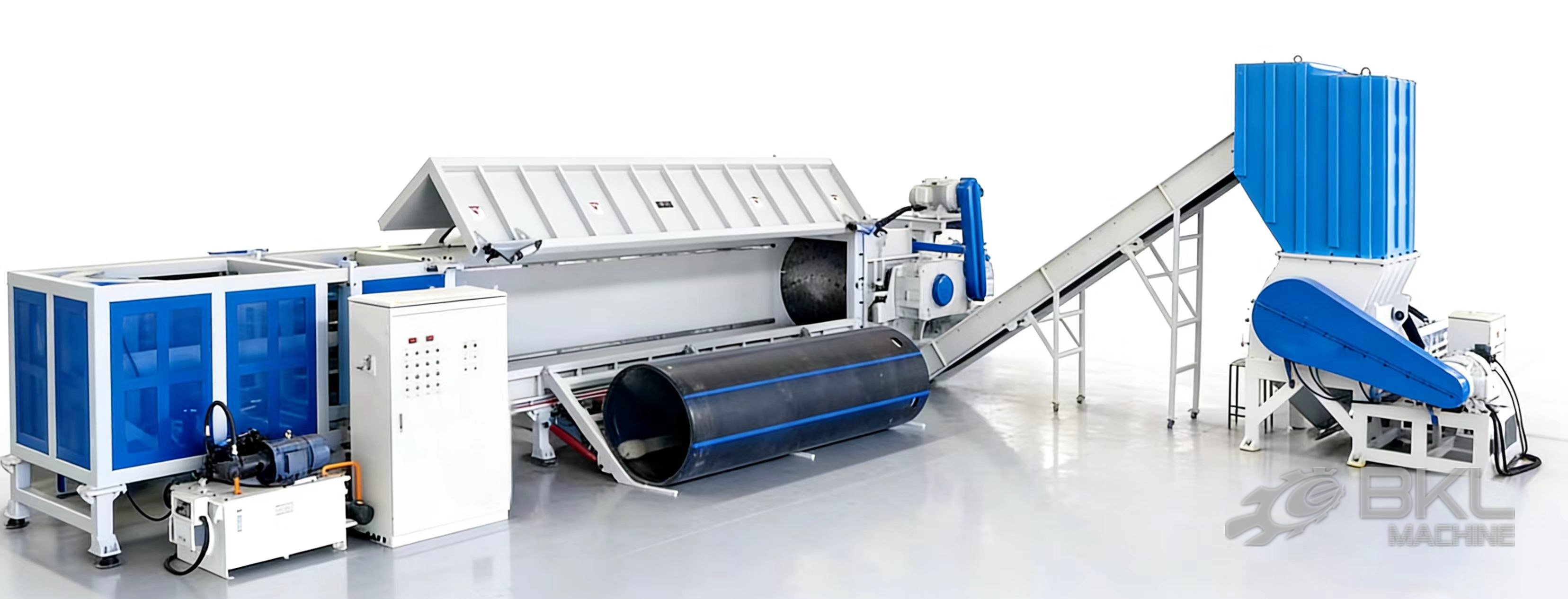 LPS long-pipe shredder line with a large diameter HDPE pipe at the infeed, belt conveyor and crusher