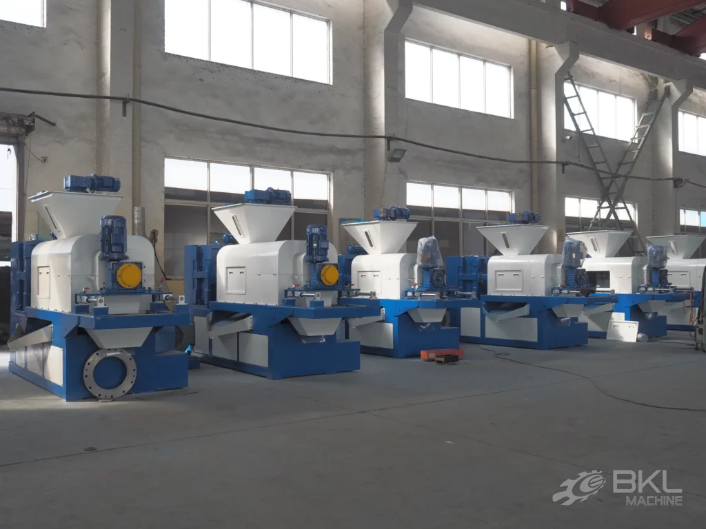 Row of six JG squeezer units lined up across the assembly workshop before shipment