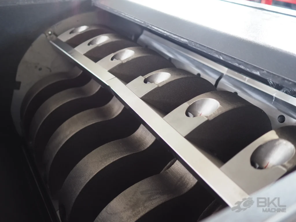 Close-up of crusher rotor blades in helical arrangement beside the fixed counter knife bar