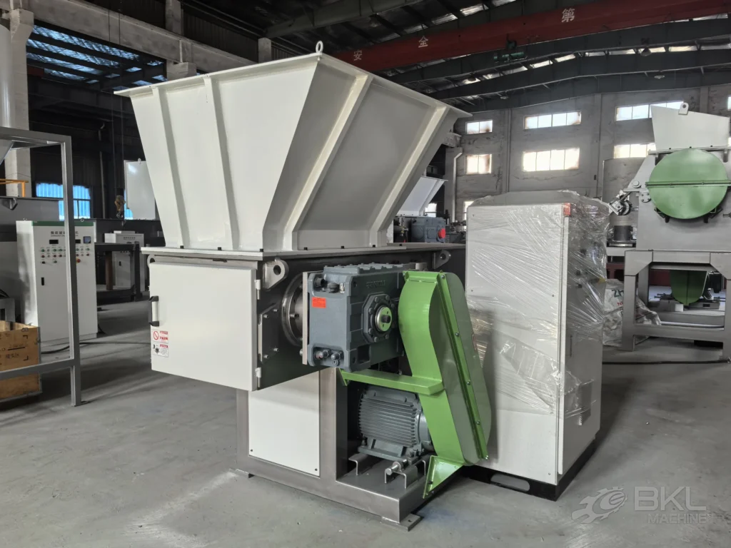 SS600 shredder standing on the workshop floor with its control cabinet still wrapped for shipping