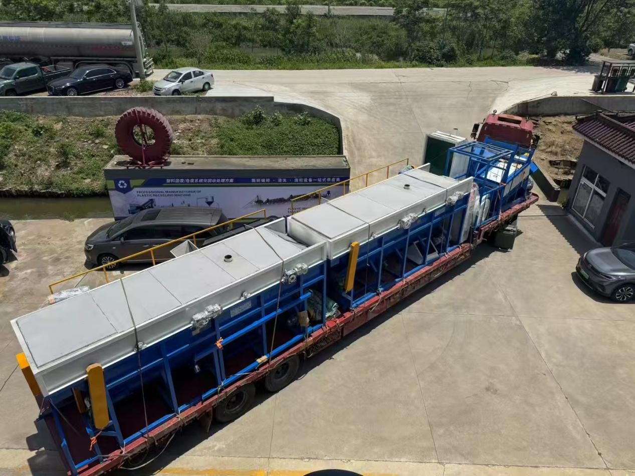 Covered flotation washing tanks strapped to a flatbed trailer seen from above before shipment by BKL-MACHINE