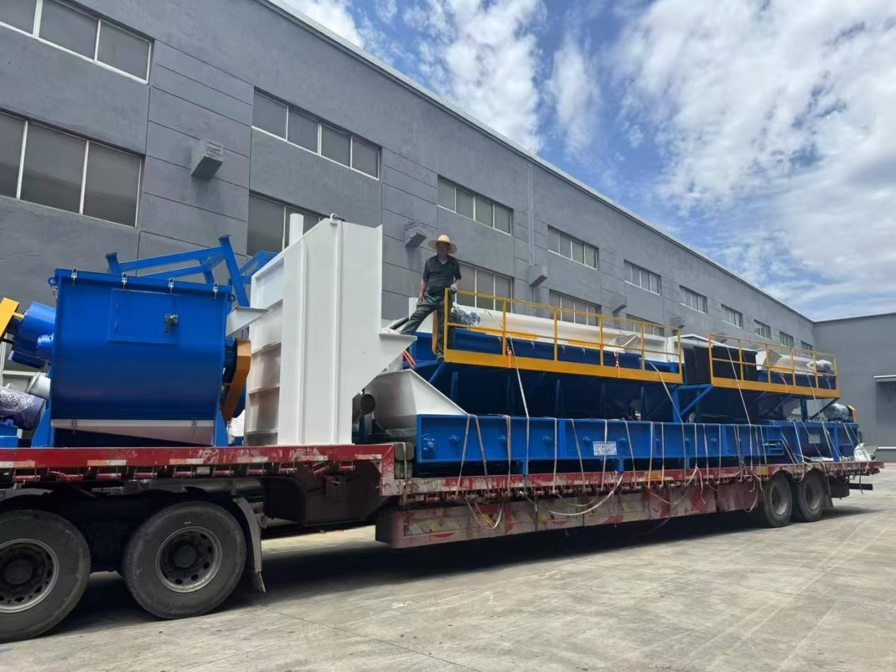 Flatbed truck loaded with the friction washer and flotation tanks of an HDPE drum washing line at BKL-MACHINE