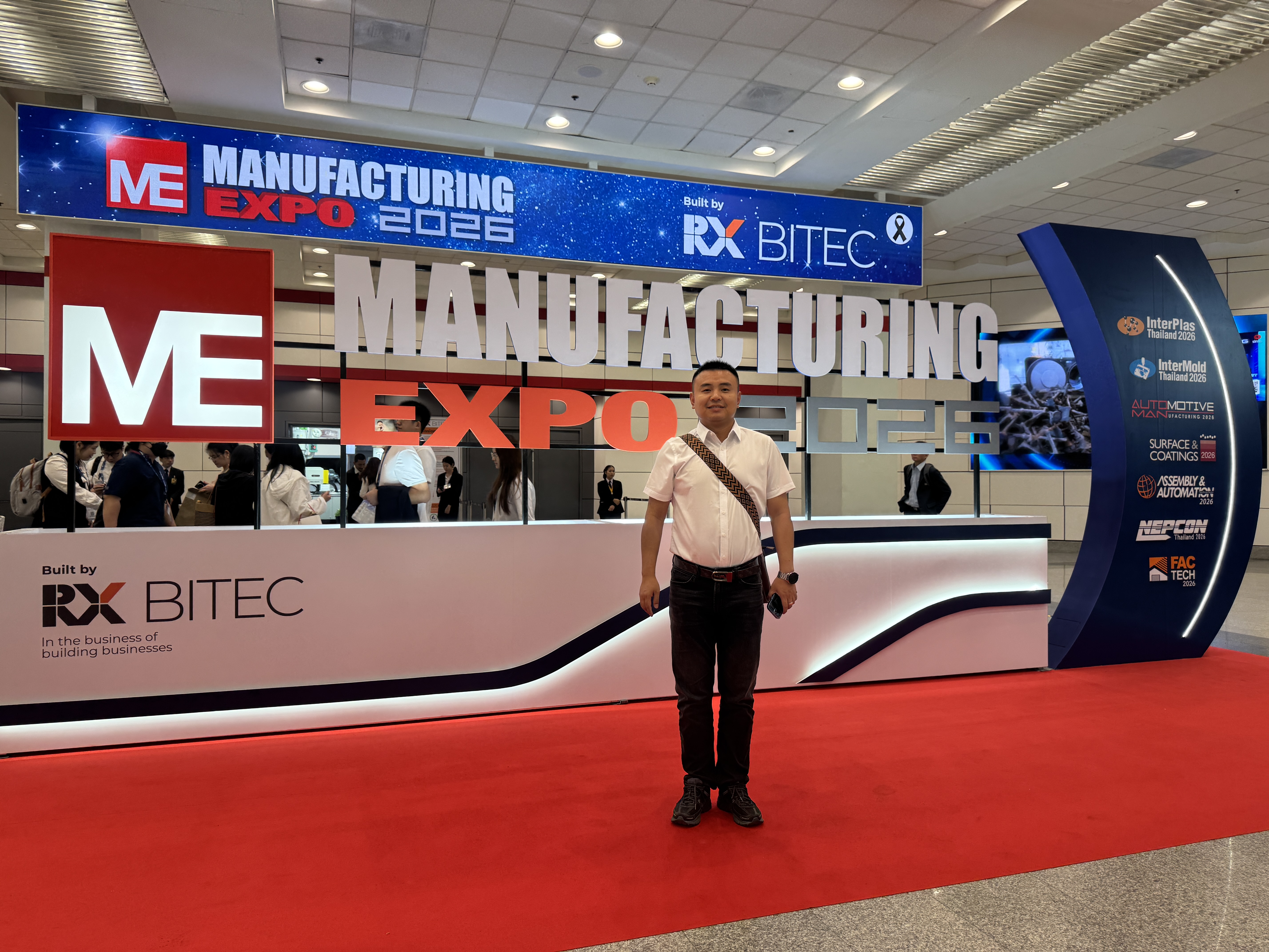 Team member at the Manufacturing Expo 2026 entrance signage in Bangkok, the show attended by BKL-MACHINE