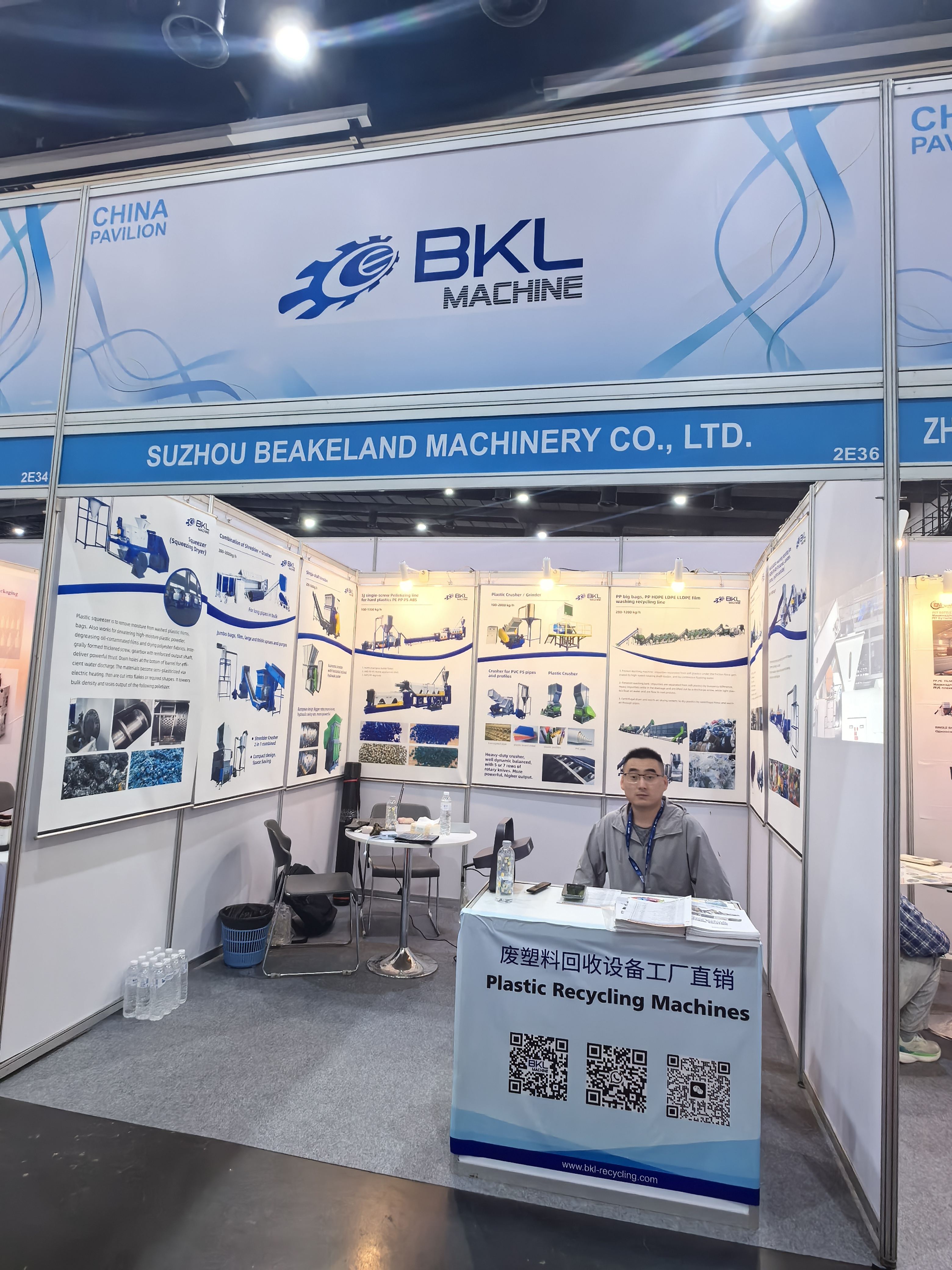 Booth 2E36 in the China Pavilion with the product poster wall and reception desk at BKL-MACHINE