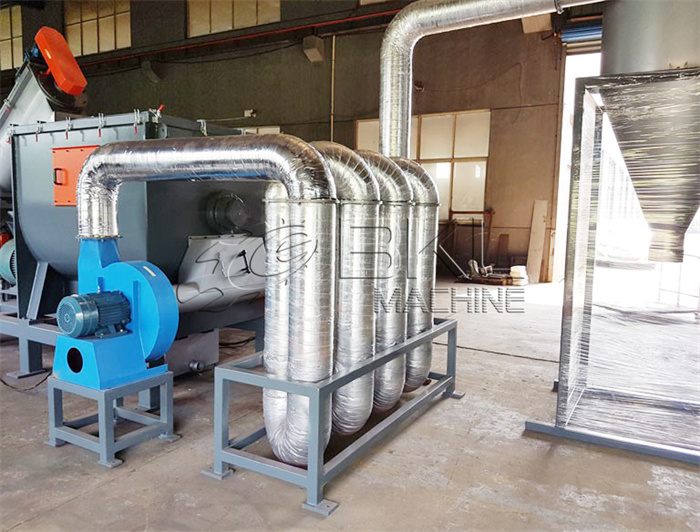 Installed pipe drying system with a blue blower, stainless ducting rising towards the roof and a cyclone separator alongside.