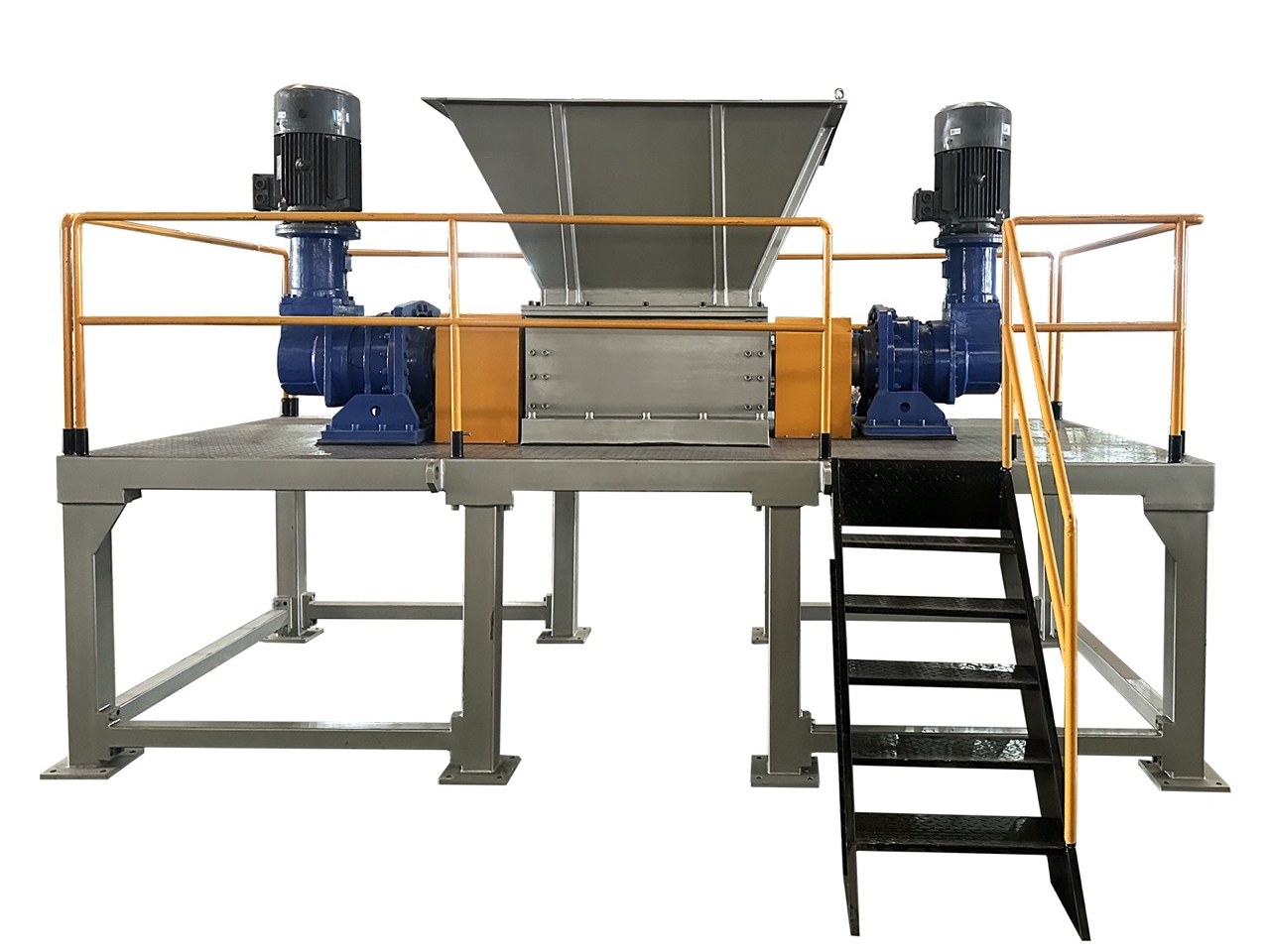 DS twin-shaft tire shredder on a raised steel frame with safety railing, access stairs and two gear-motor drives