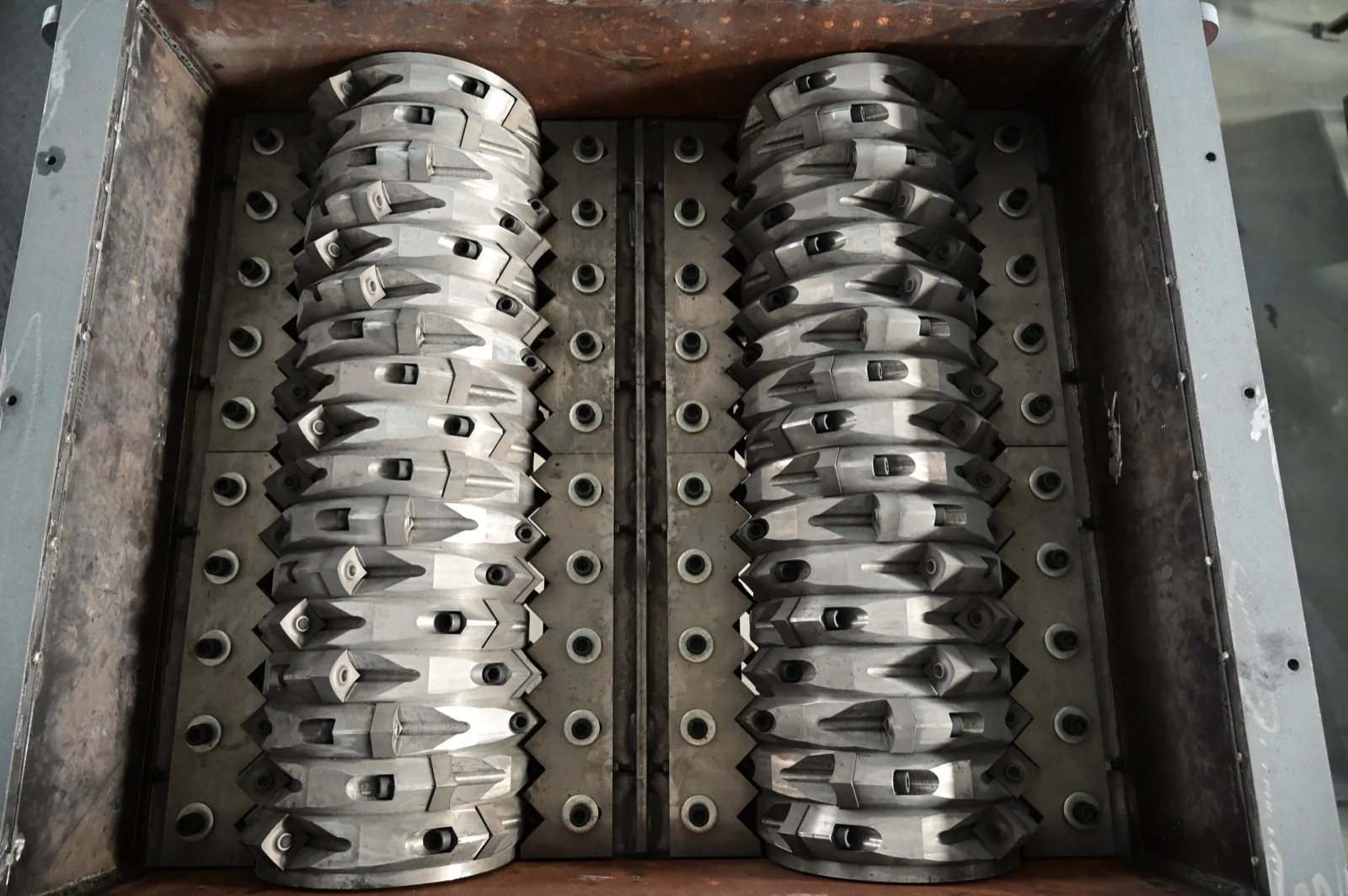 Close-up of twin shredder rotors fitted with carbide-tipped teeth, the tooling grade required for shredding steel-belted tyres