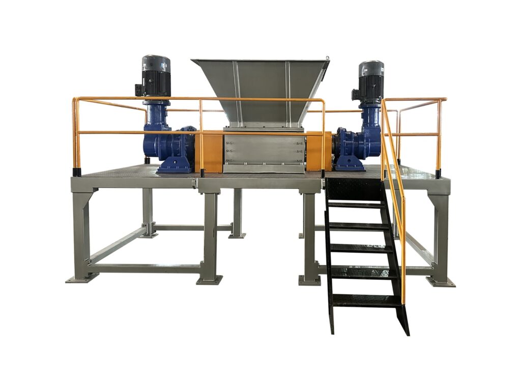 DS twin-shaft tire shredder on a raised steel frame with safety railing, access stairs and two gear-motor drives
