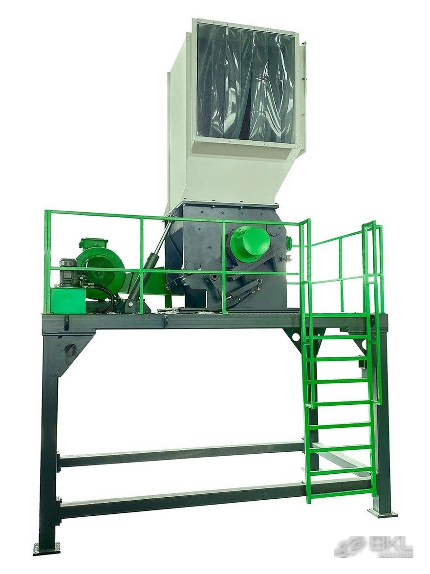 Heavy-duty plastic crusher on an elevated steel platform with tall feed hopper and side-mounted drive motor